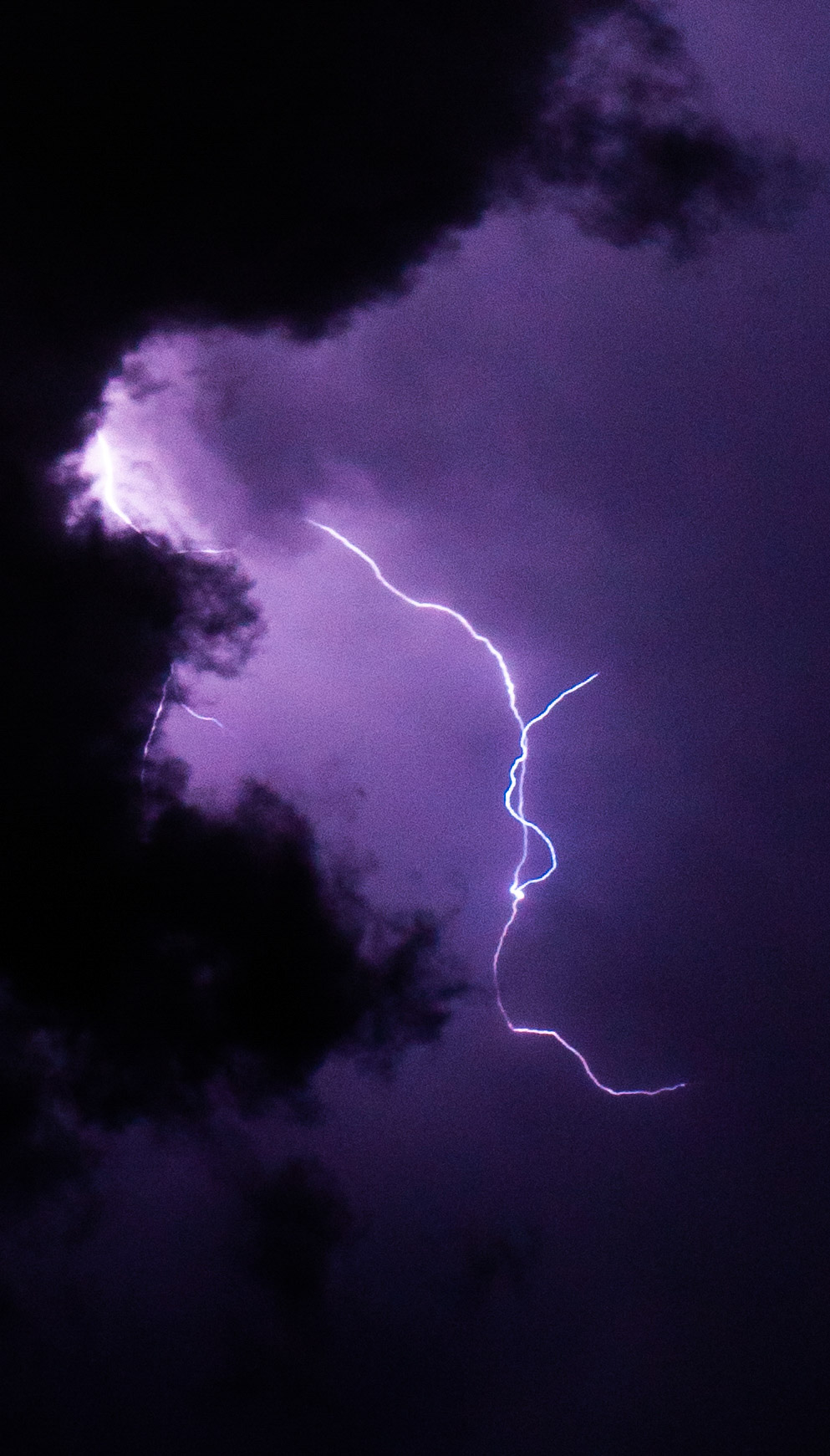 Lighting seeps through clouds (purple)